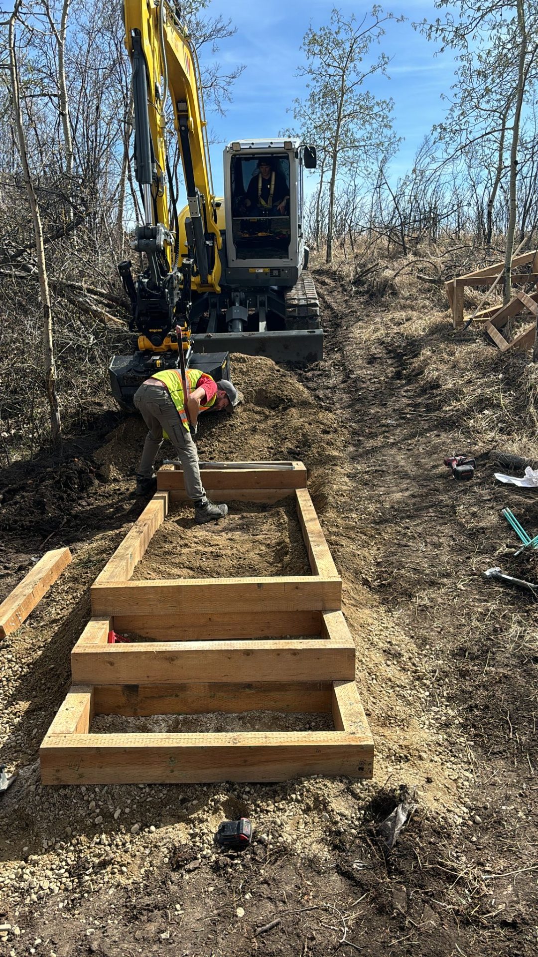 Crew rebuilding timber stairs after excavation